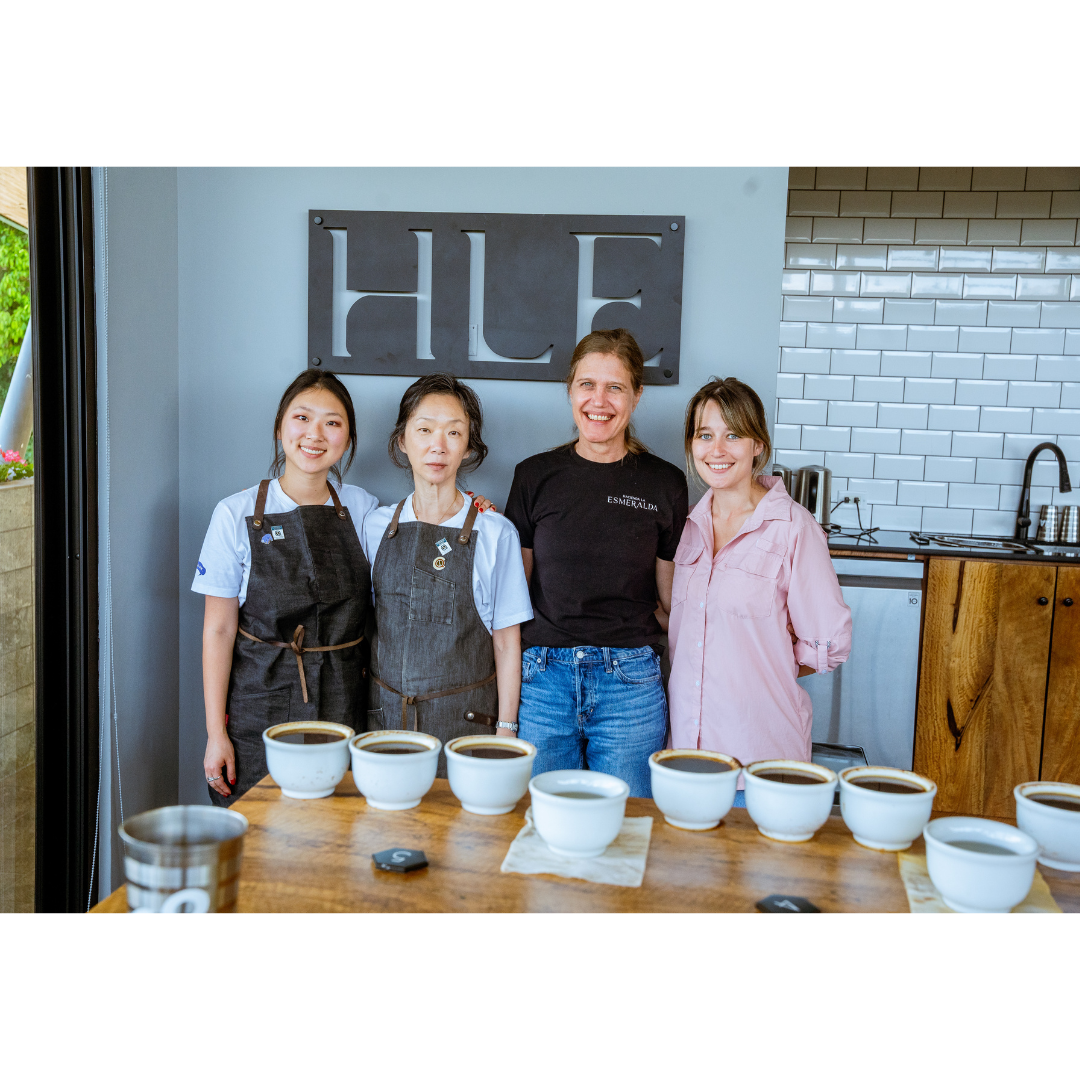Jiyoon and Rachel stand in front of a Hacienda La Esmeralda sign with the producers