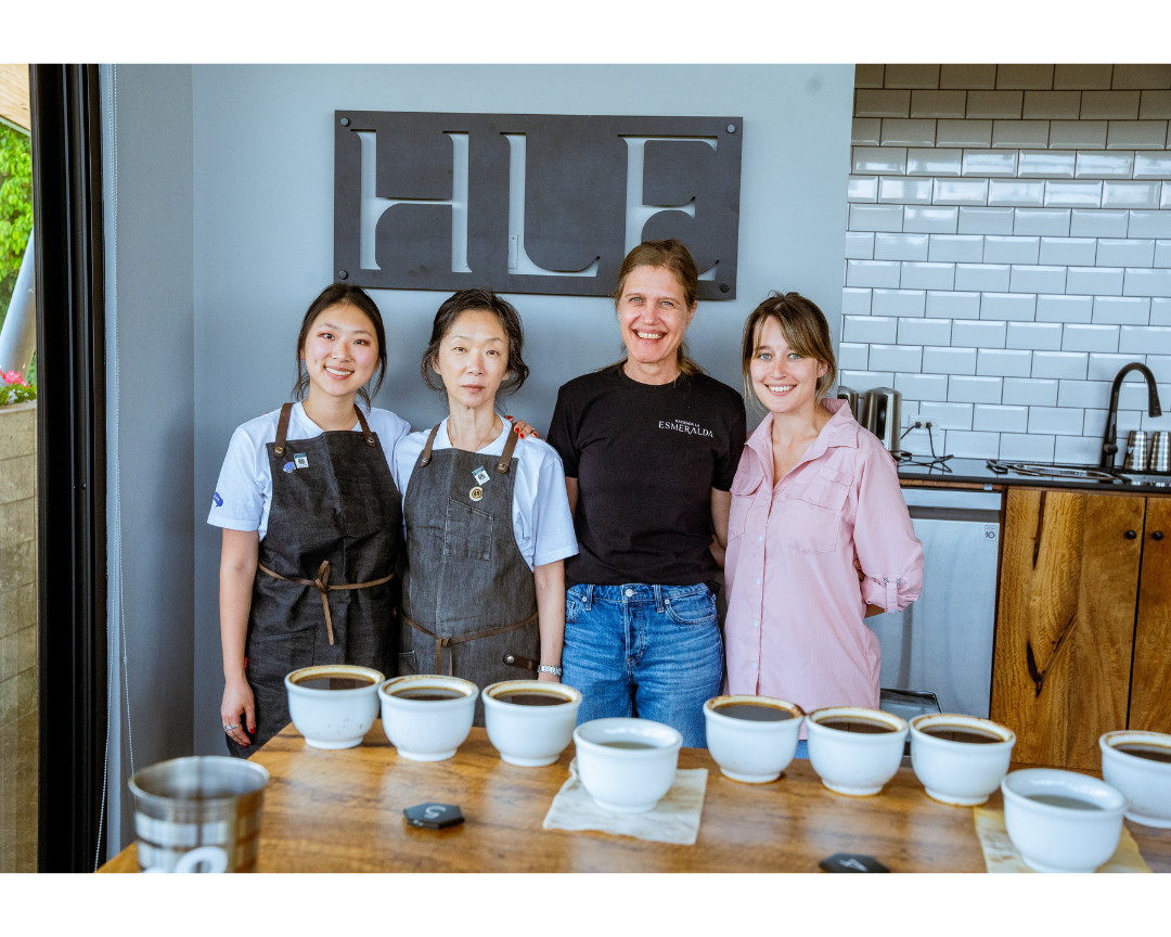 Jiyoon and Rachel stand in front of a Hacienda La Esmeralda sign with the producers