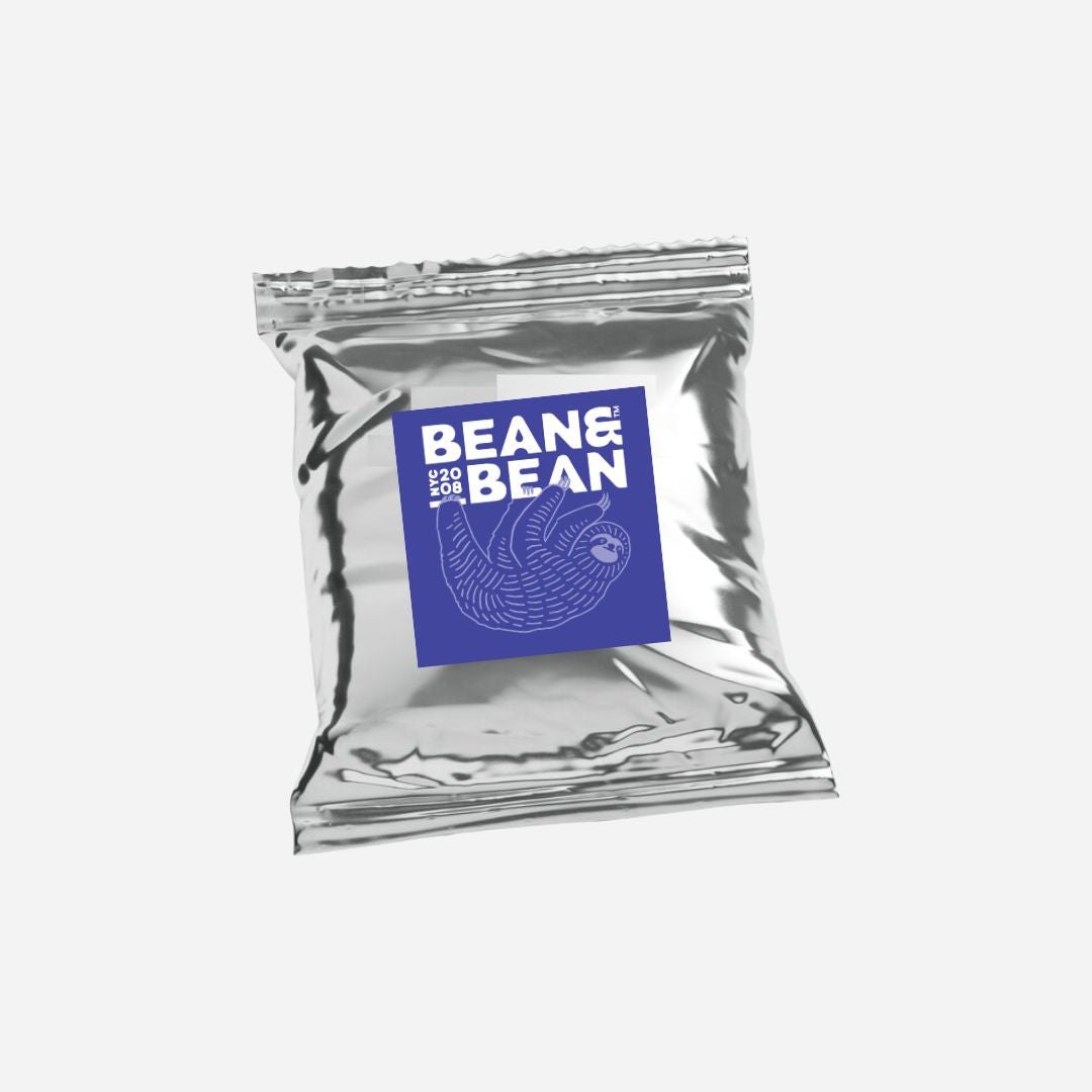 silver fractional bag with sloth hanging on Bean and Bean logo, all on white solid background. 
