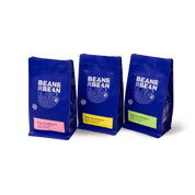 3 Purple "Bean & Bean Coffee Roasters" bag with a colored label that says Kenya Yara AB Washed. 