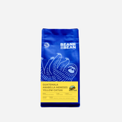 Purple "Bean & Bean Coffee Roasters" bag with a colored label that says Guatemala Santa Felisa Yellow Catuai