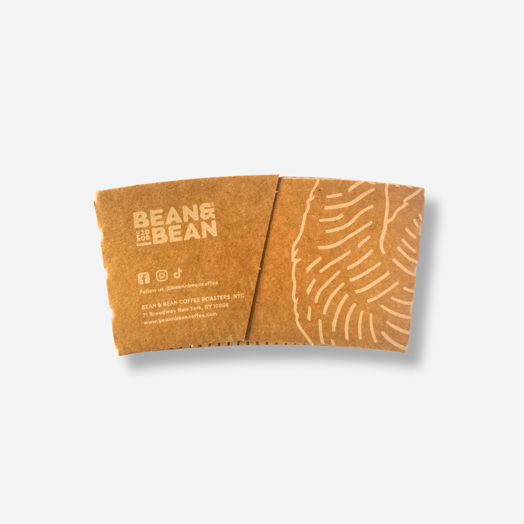 A brown craft sleeve with the “BEAN & BEAN” logo, small social media icons, and location/website text on the left, plus a light pattern graphic on the right.